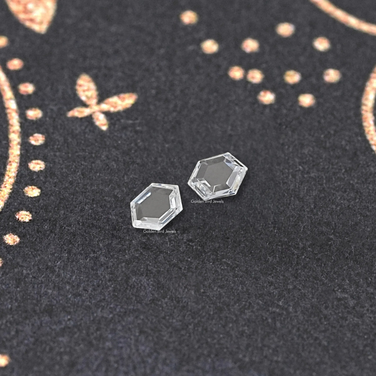 Loose hexagon lab-grown diamond pair, two clear faceted stones on display