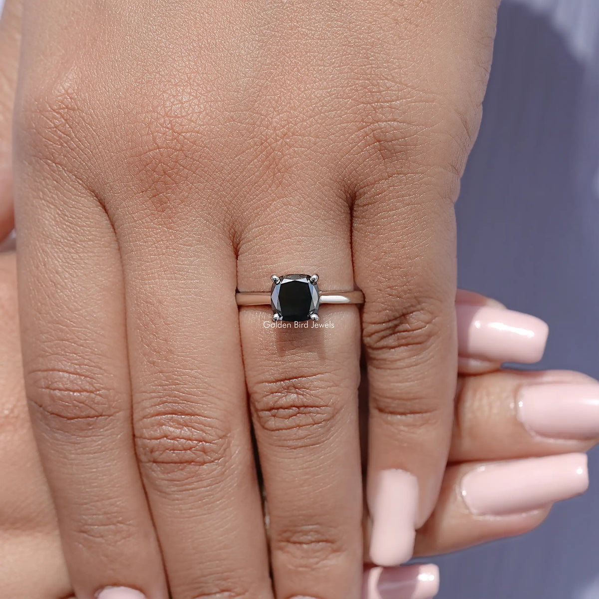 925 sterling silver cushion-cut solitaire ring with black moissanite on finger