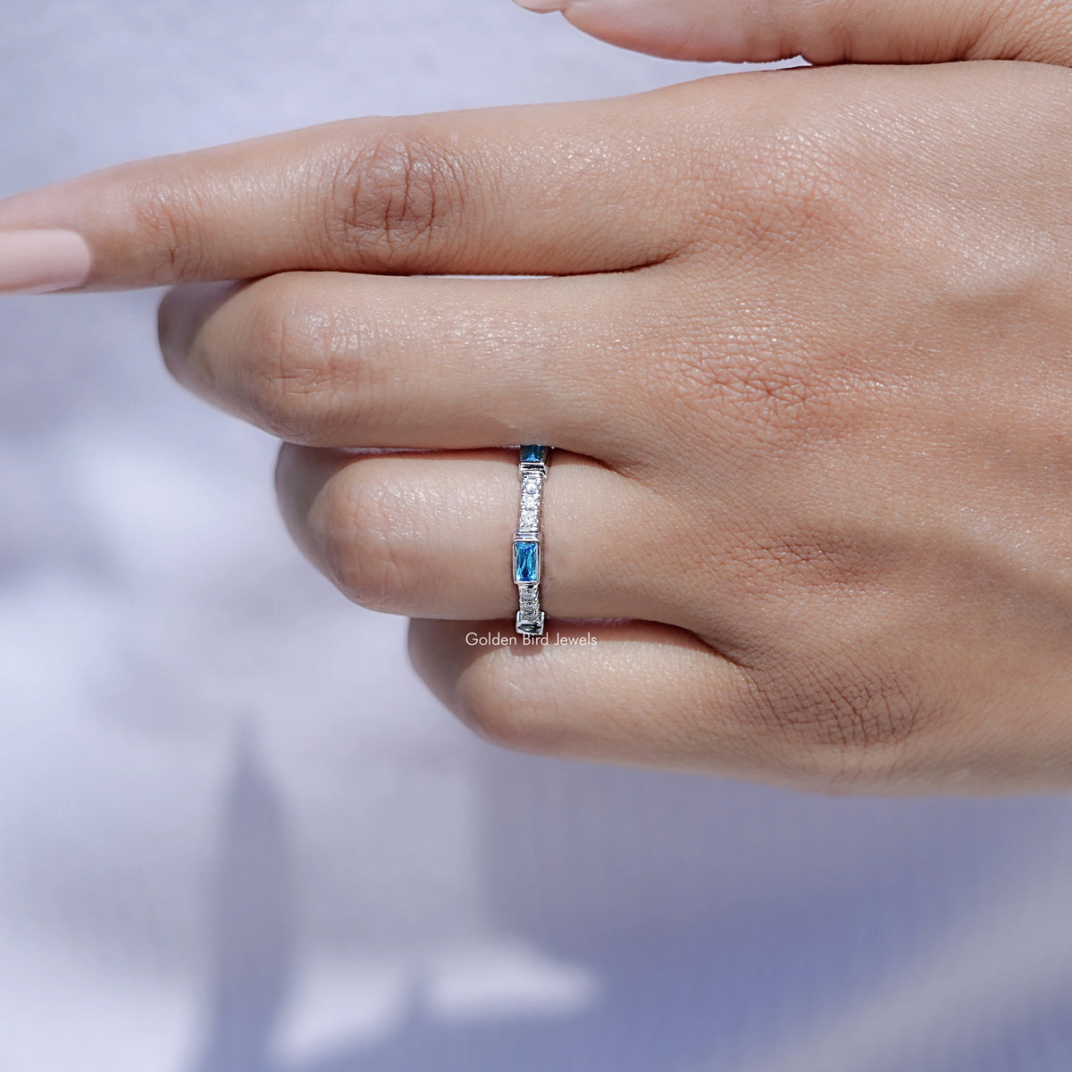 In front finger View Of Baguette gemstone engagement ring