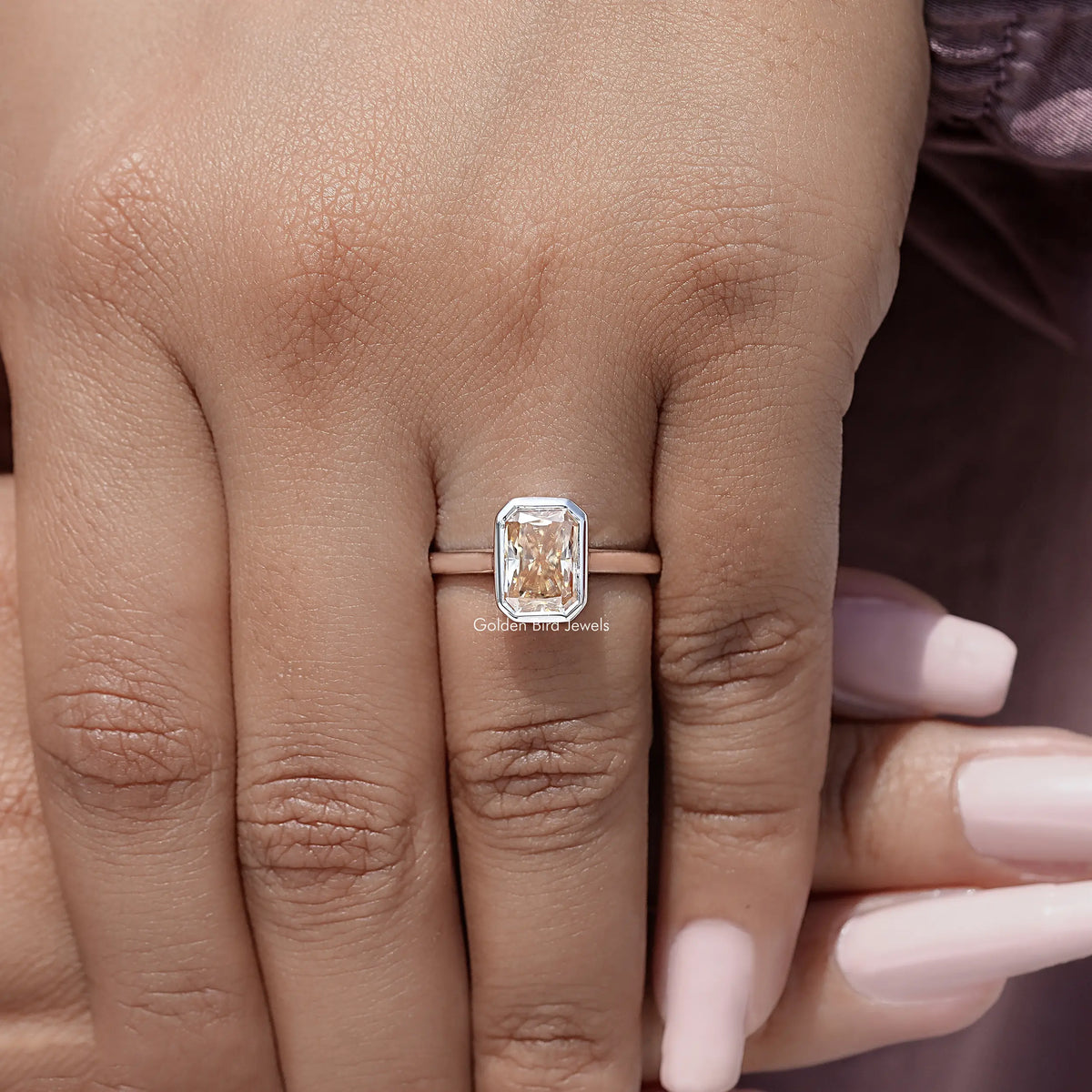 Radiant-cut solitaire ring, rose-gold band with bezel-set square stone