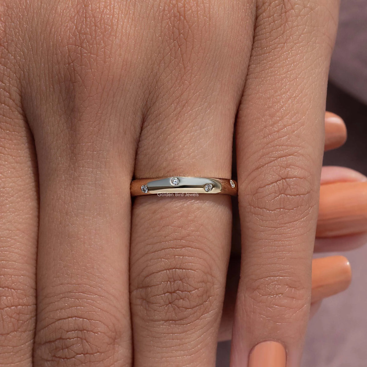 Flush-set diamond eternity band ring on hand, centered front view with round diamonds