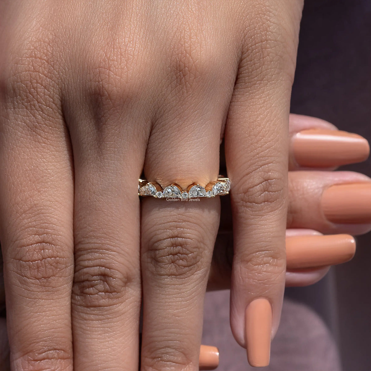 Diamond full eternity band ring with repeating stone settings, front view on hand