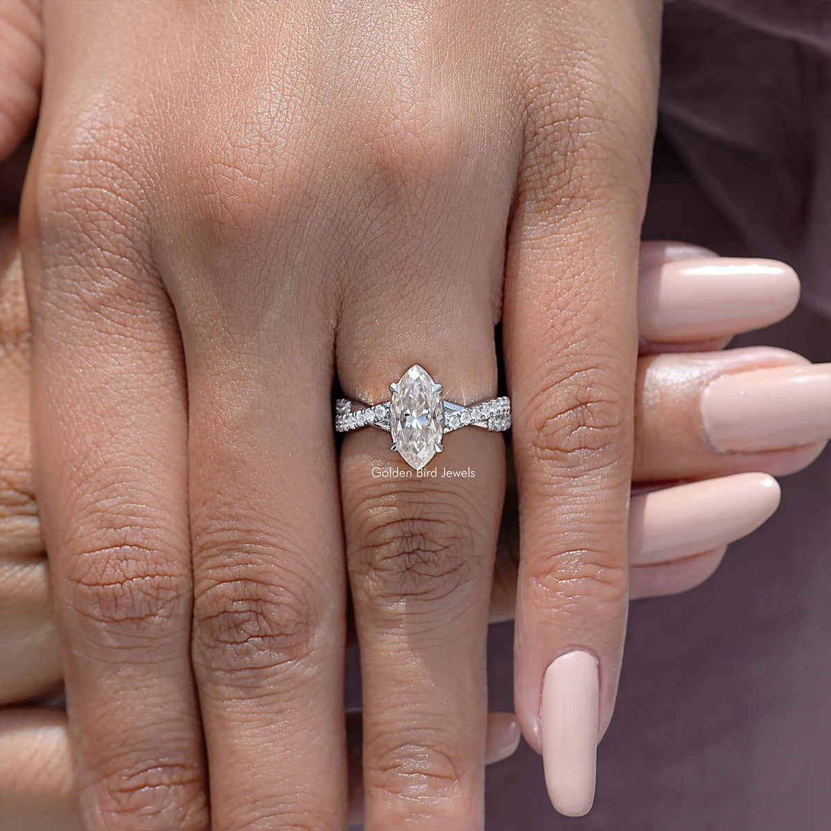 Twisted accent wedding ring with marquise center stone and prong-set side stones