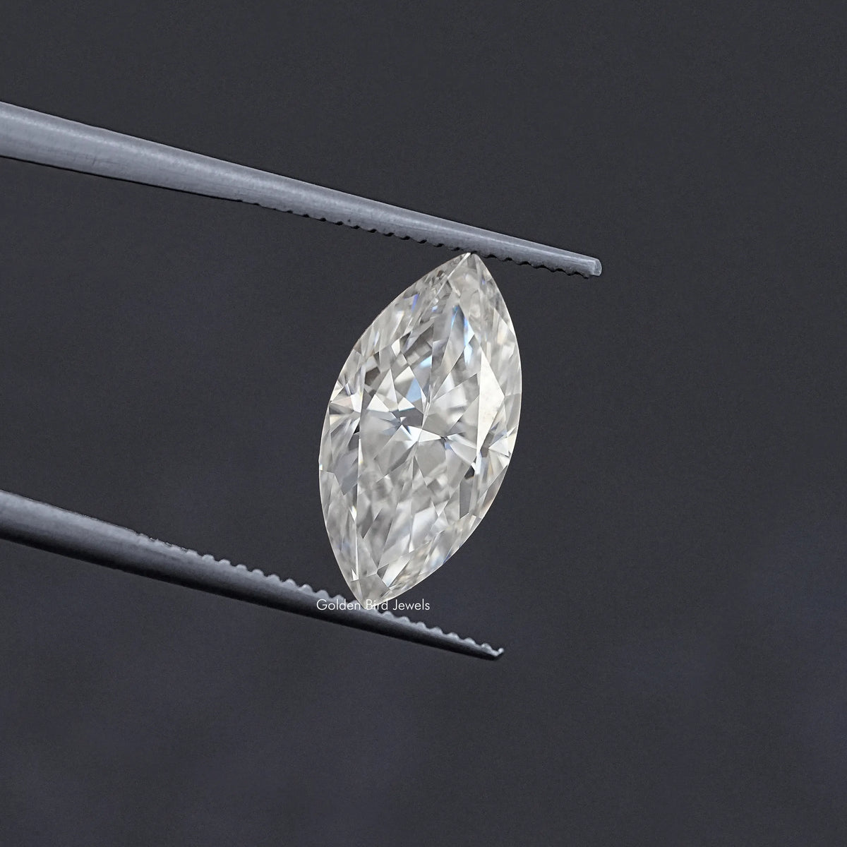 Marquise-cut moissanite loose stone held in tweezers, clear white marquise shape