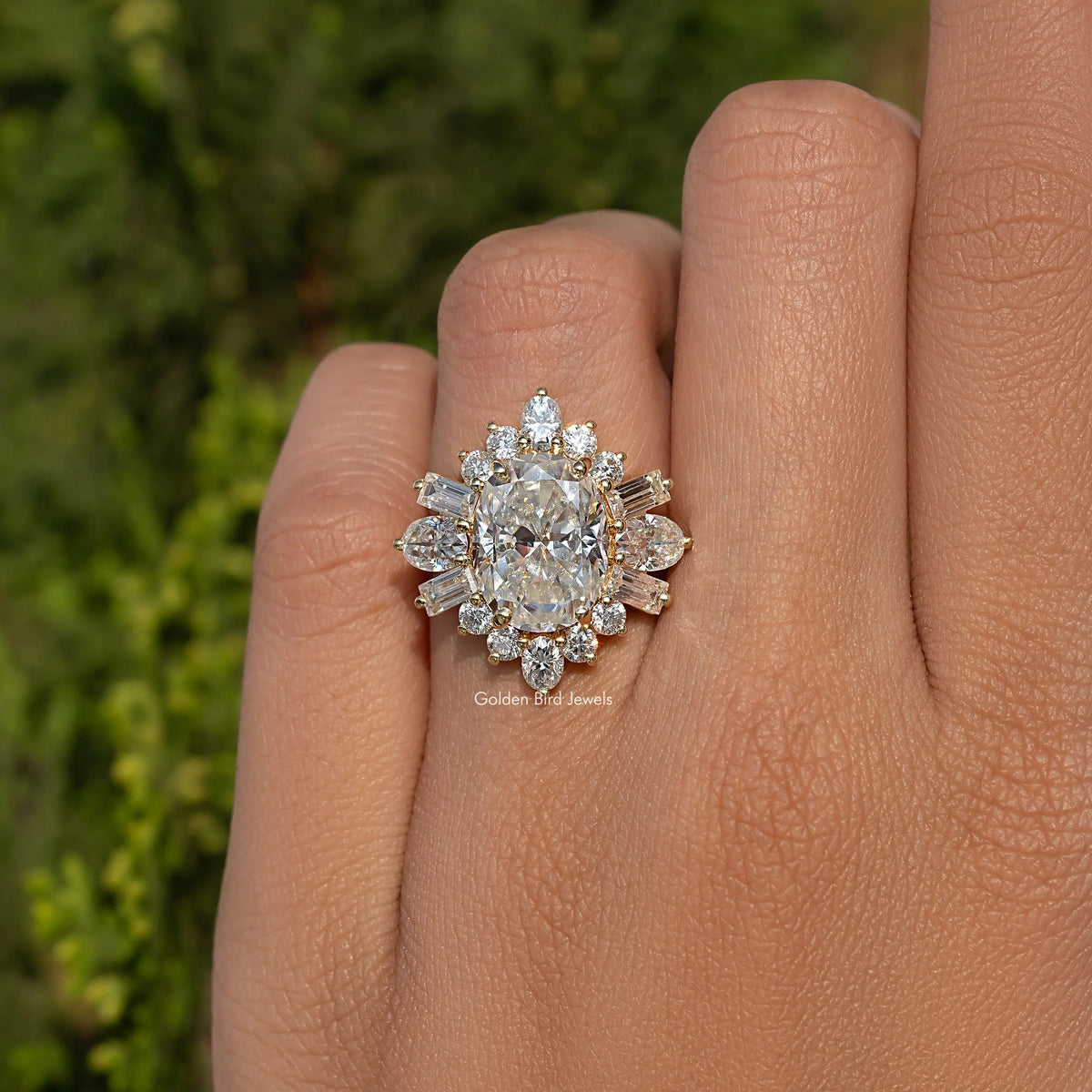 Oval moissanite halo engagement ring with round and baguette stones, metal-tone on finger