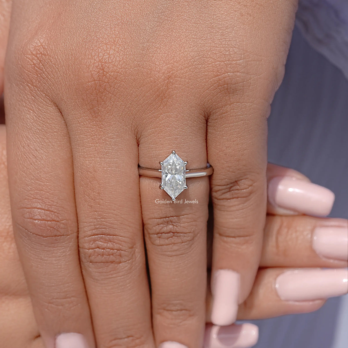 Sterling silver marquise moissanite solitaire engagement ring, front view on hand