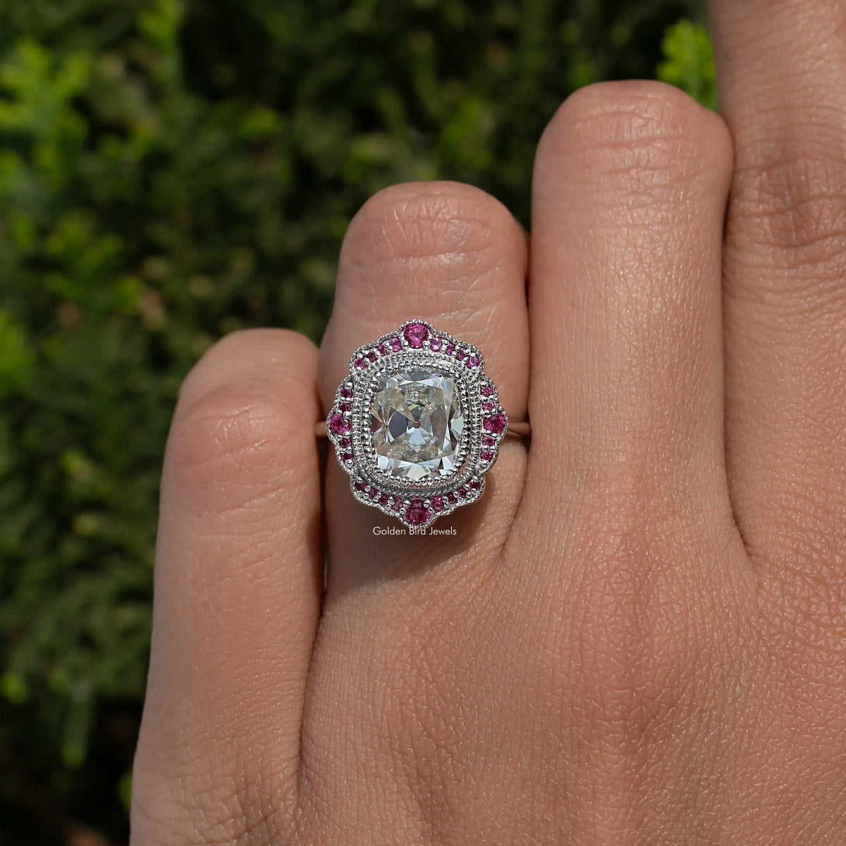 Sterling silver cushion-cut moissanite halo ring with pink gemstone border
