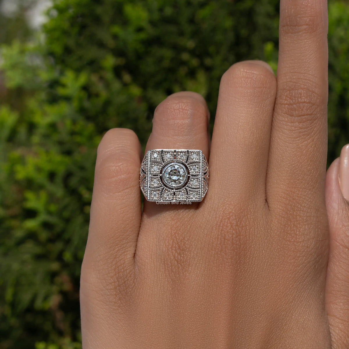 Art deco square moissanite ring with round center stone on finger
