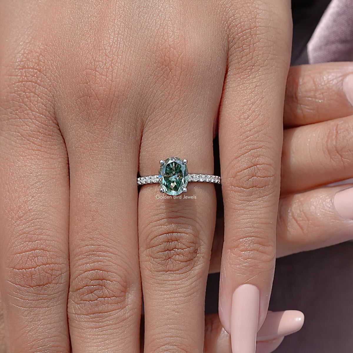 Oval cut moissanite solitaire ring with pavé accent band in sterling silver