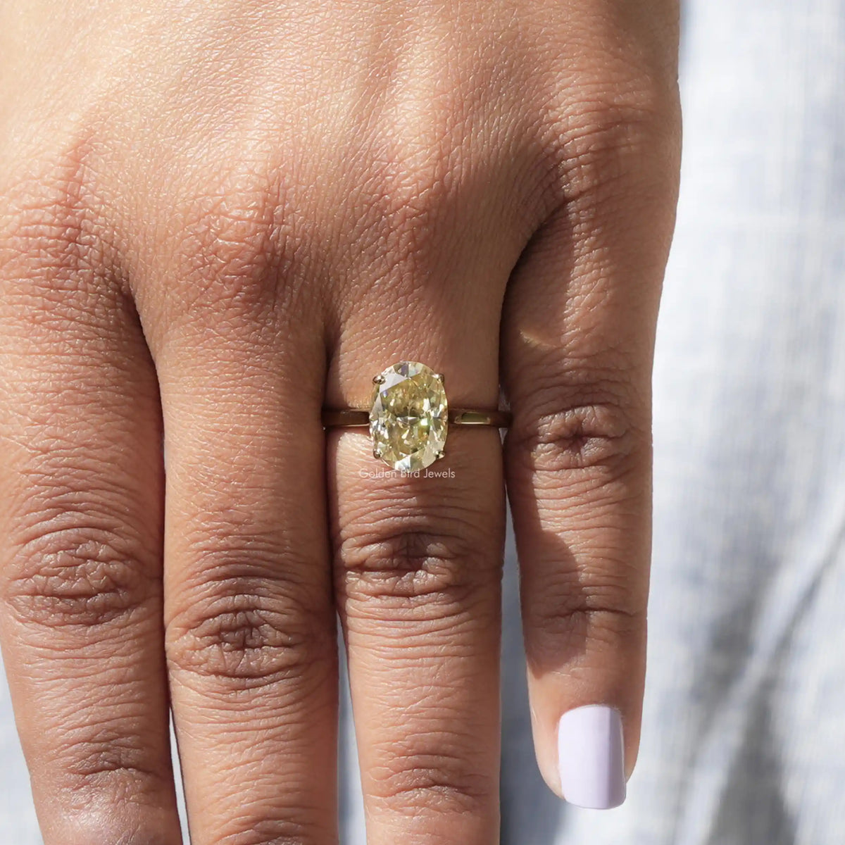 Close-Up View of Oval Cut Moissanite Solitaire Ring In Yellow Gold