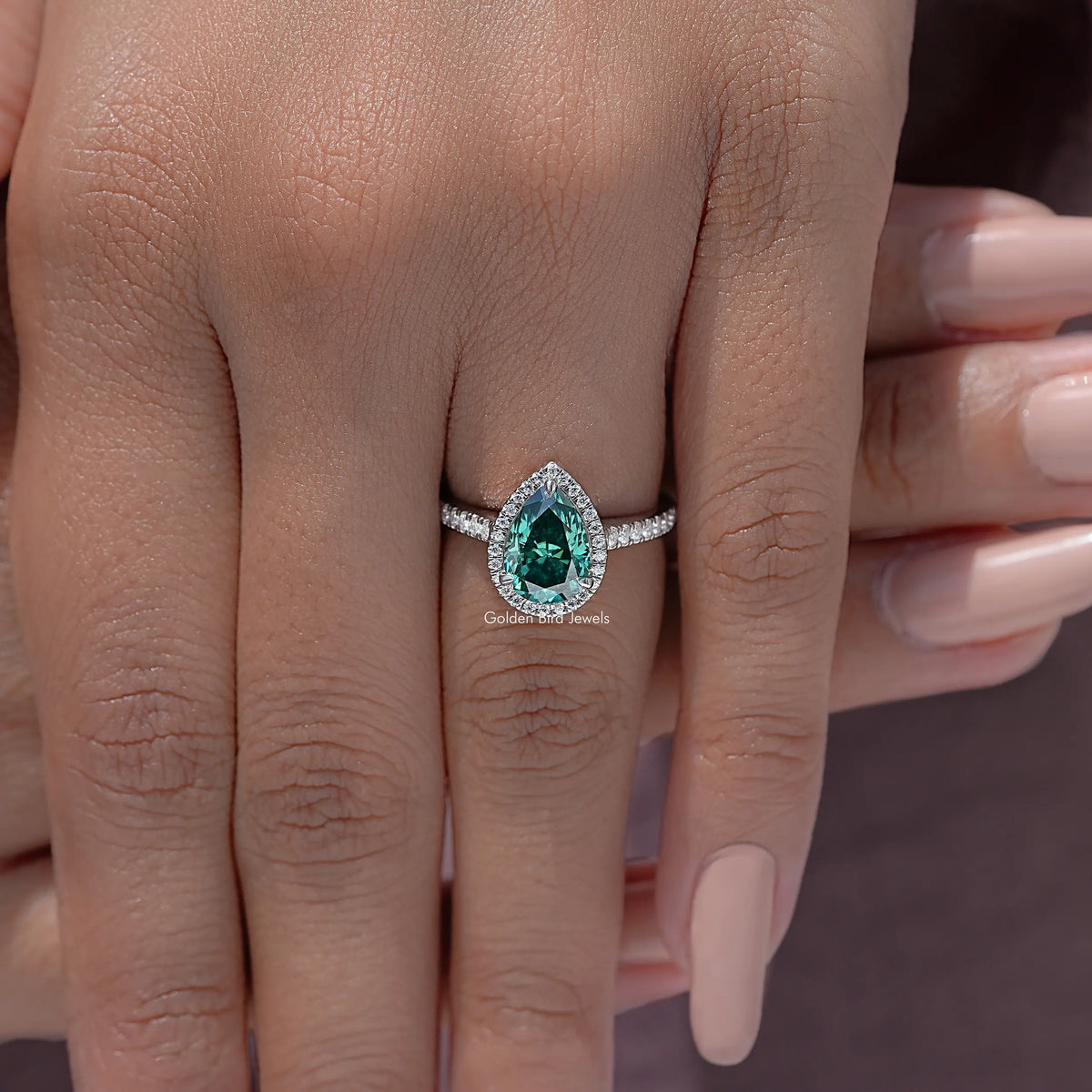Sterling silver halo wedding ring with green pear moissanite and sparkling side accents