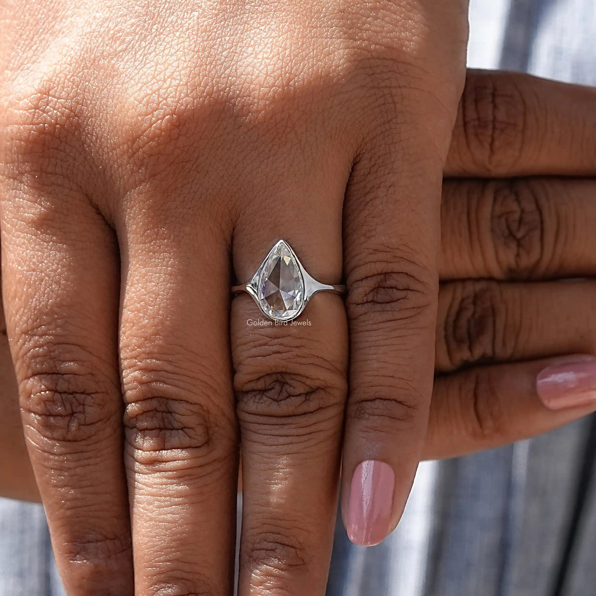 Close-Up View of Pear Cut Bezel Set Moissanite Ring In White Gold