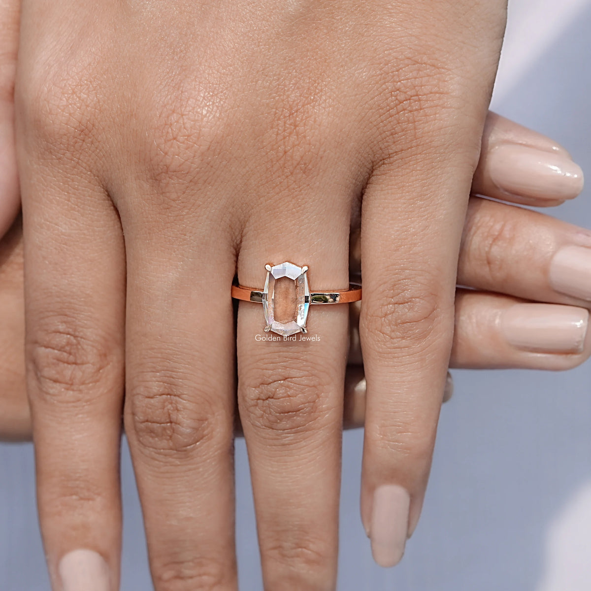 In finger front view of Portrait Cut Hexagon Moissanite Ring in unique shape