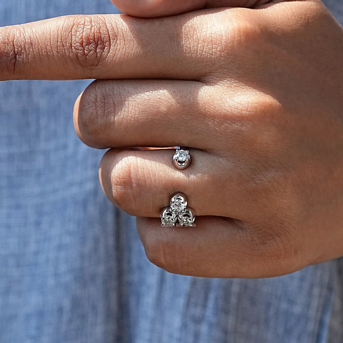 Silver-tone open cuff ring with round moissanite cluster, worn on finger