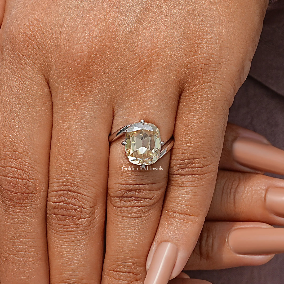 Sterling silver bypass shank solitaire ring with cushion-cut clear moissanite on fingers