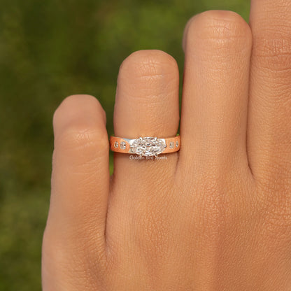 Gold moissanite ring with engraved band detail and oval center stone