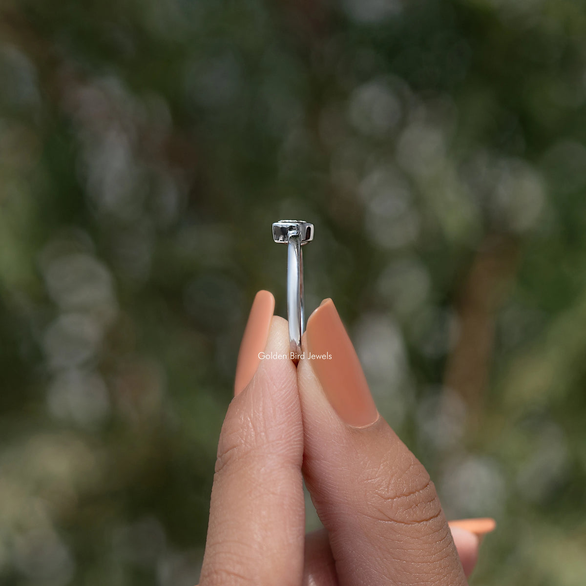 Silver solitaire ring with bezel-set pear-shaped diamond, view of the setting