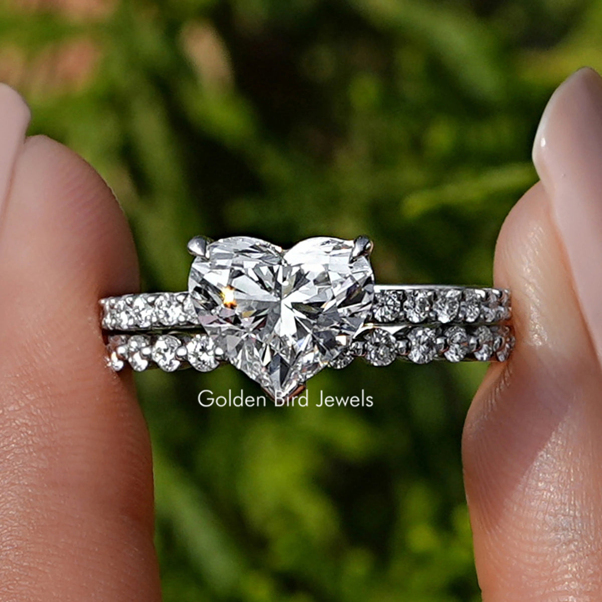Heart Shaped Lab Diamond Bridal Ring Set held between fingers 