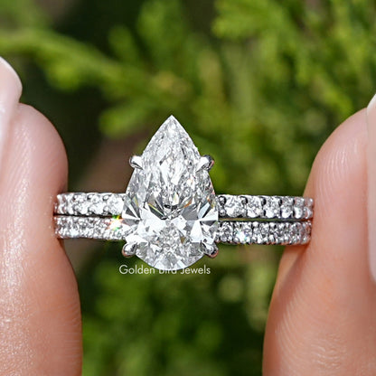 Pear-shaped diamond ring with sparkling side stones on a silver band