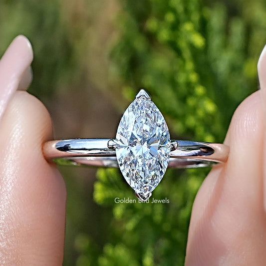 Marquise Cut Lab Grown Diamond Solitaire Ring Held Between Fingers