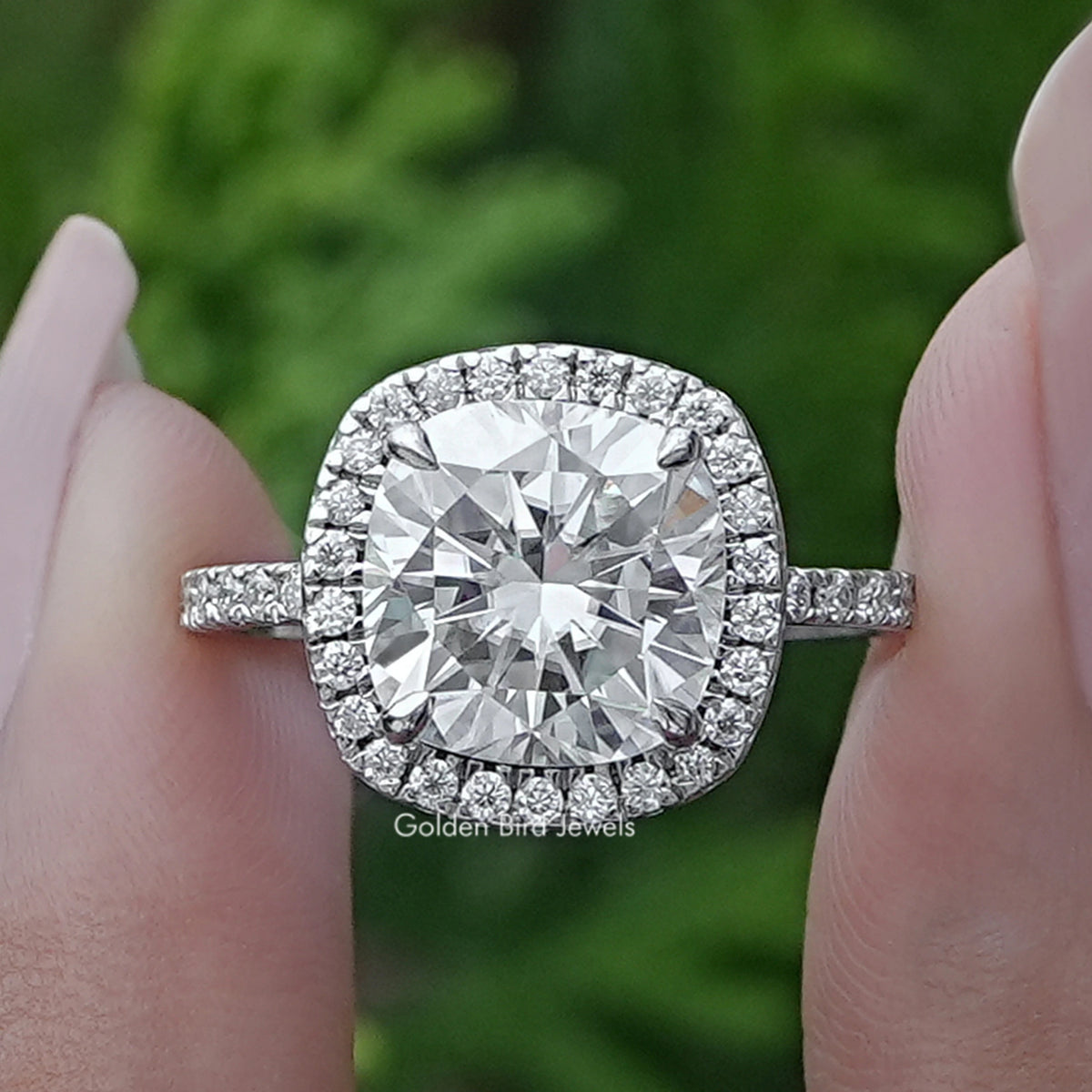 Cushion-cut diamond halo engagement ring with side baguette stones, silver-toned band