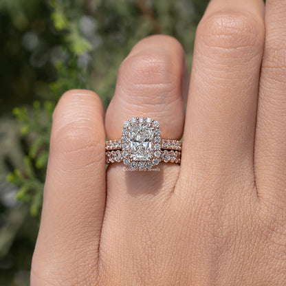 Radiant cut halo bridal ring set with pavé bands on a hand