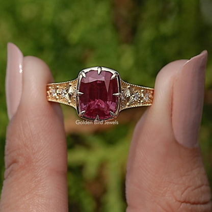 Cushion-cut gemstone ring with pavé shoulders and side stones