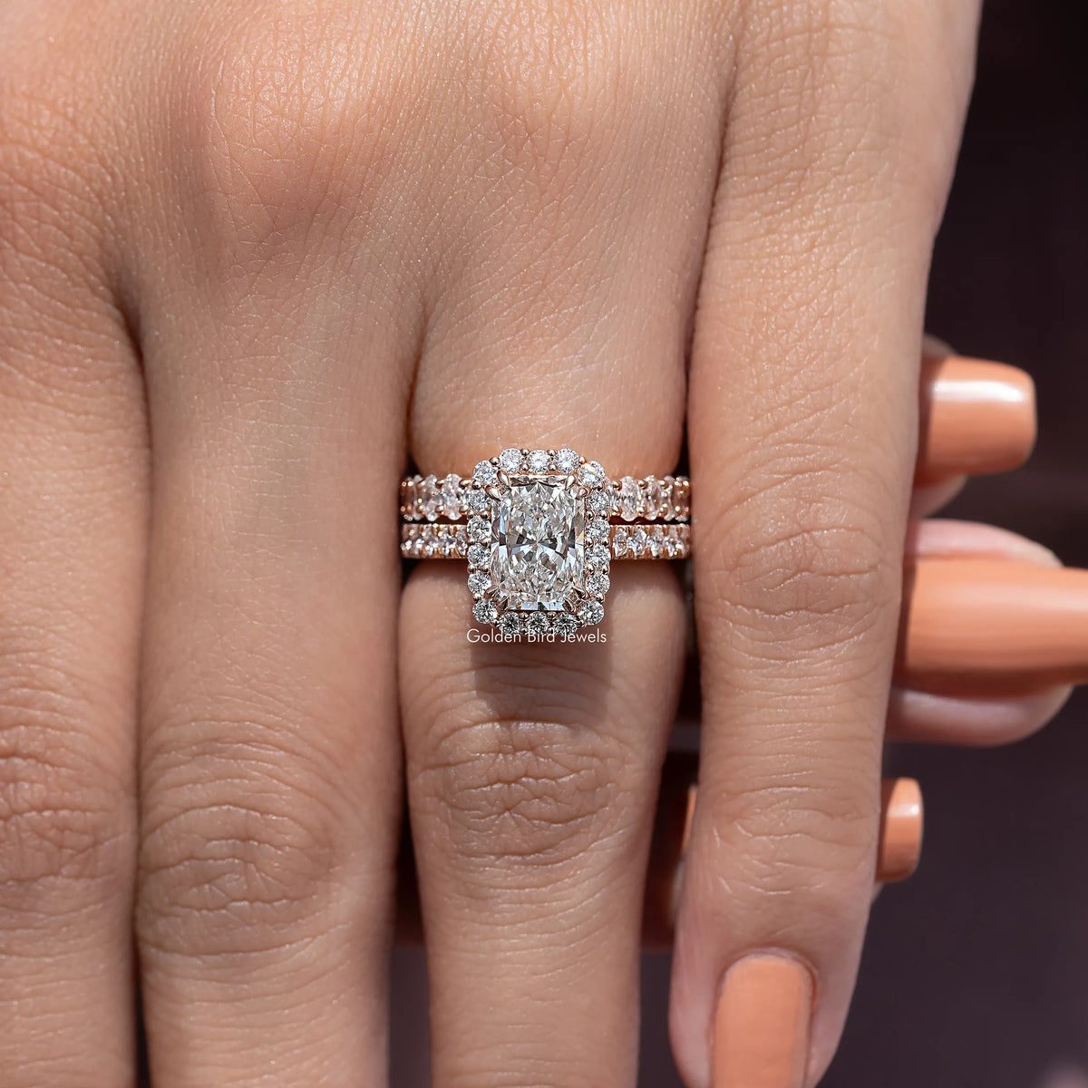 Radiant cut lab diamond halo bridal ring set on a hand