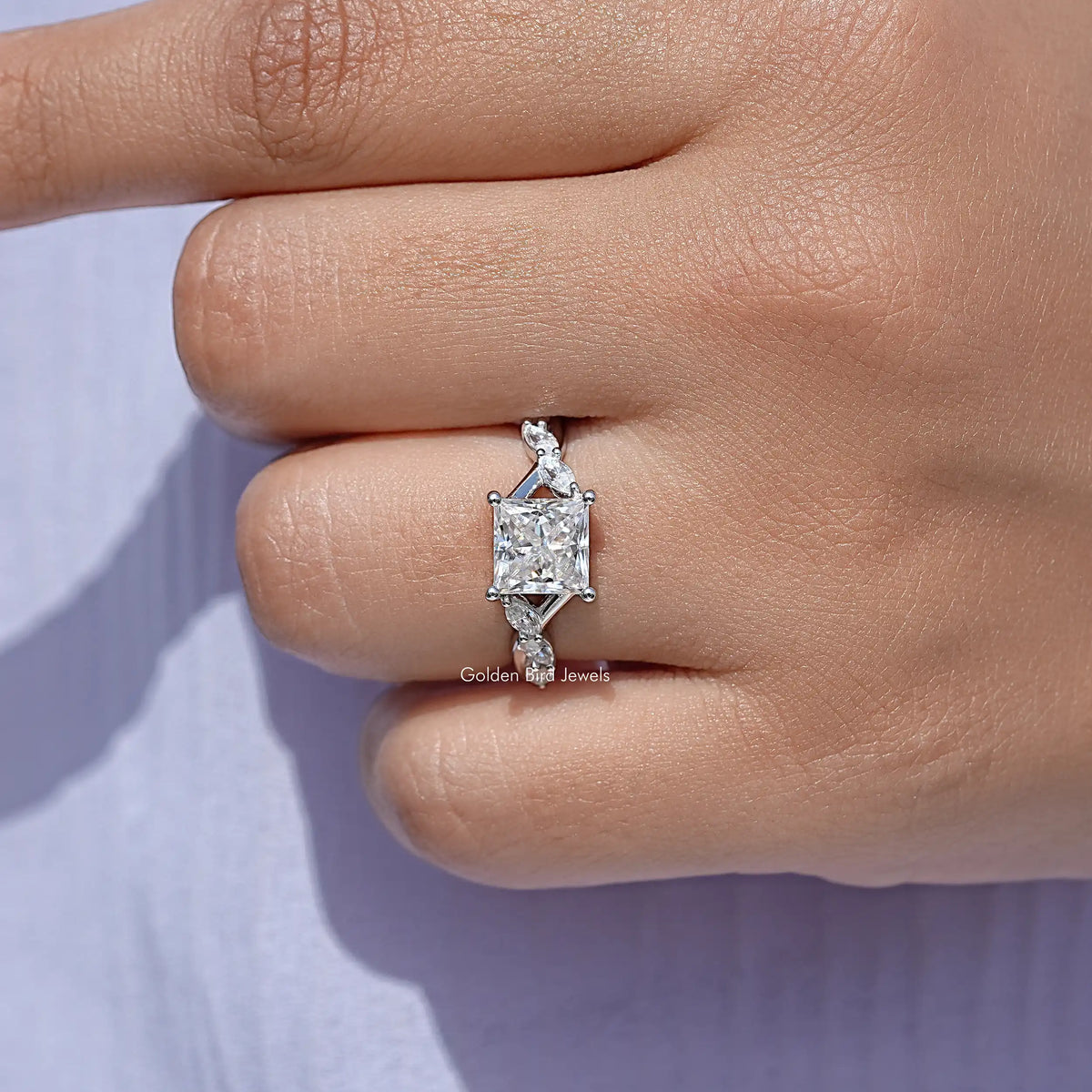 Close-up of 925 sterling silver square-cut moissanite promise ring on finger