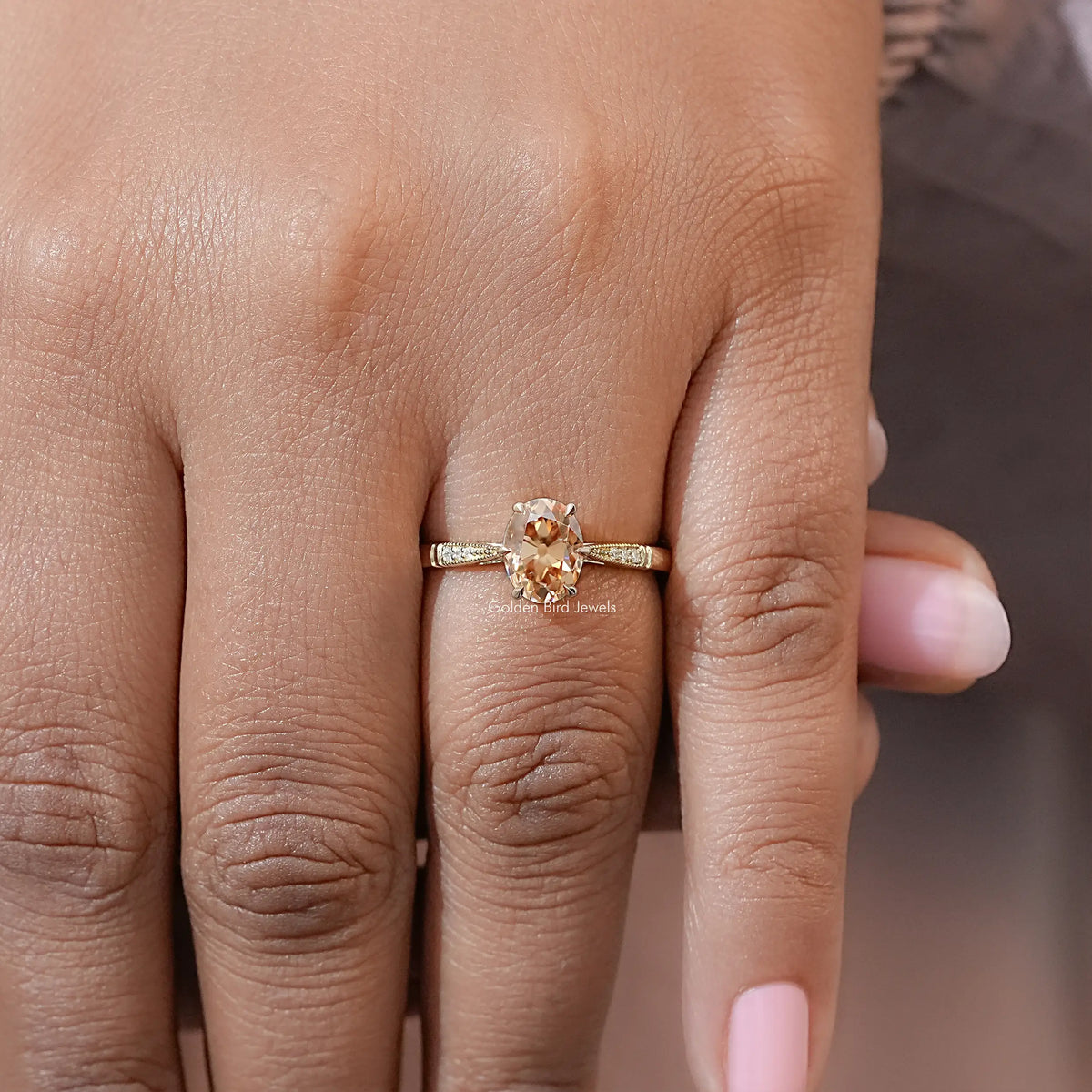 Oval moissanite solitaire engagement ring on a hand