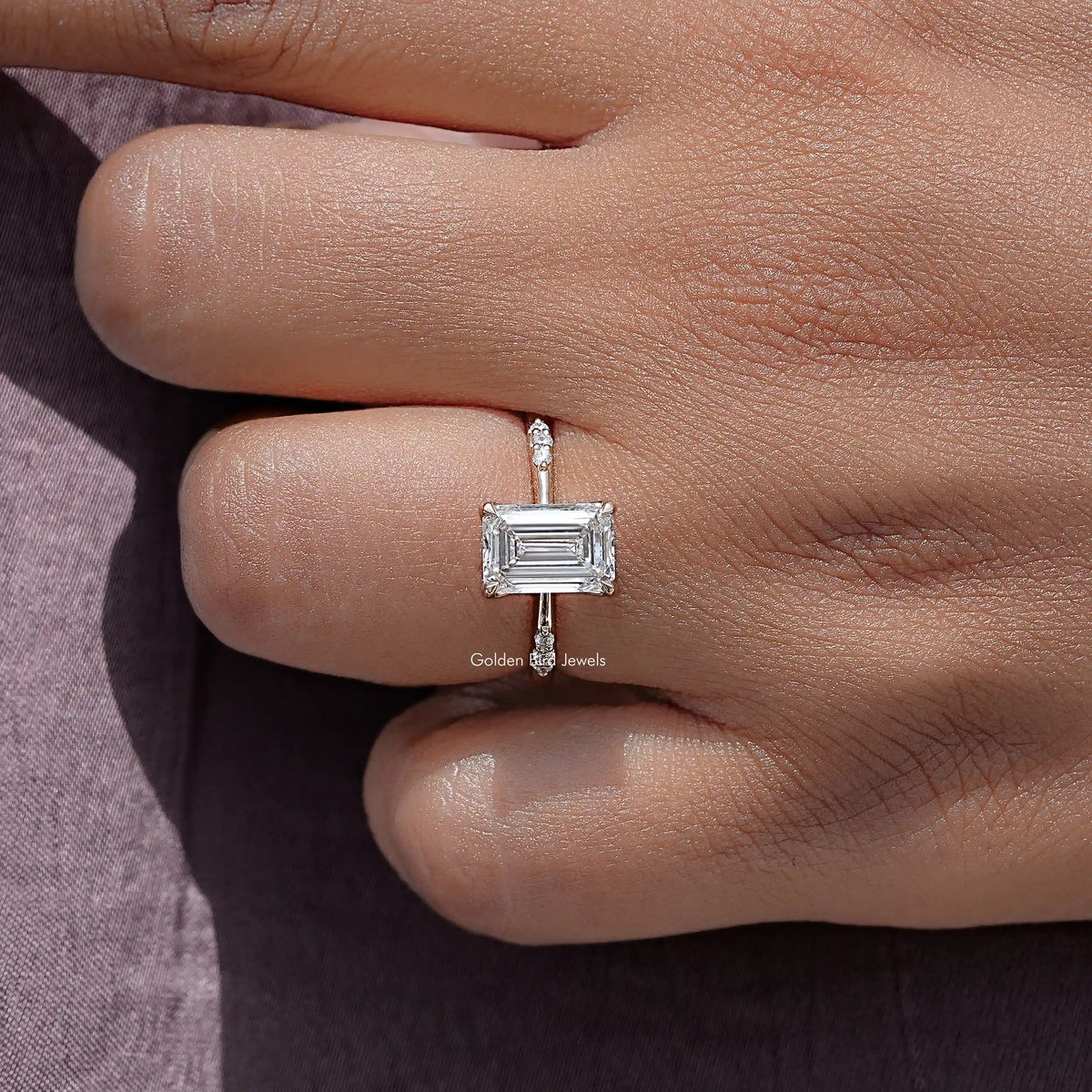 Emerald-cut lab diamond ring with square bezel setting and thin band