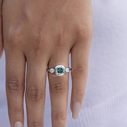 Three-stone cushion-cut moissanite ring on hand, silver band