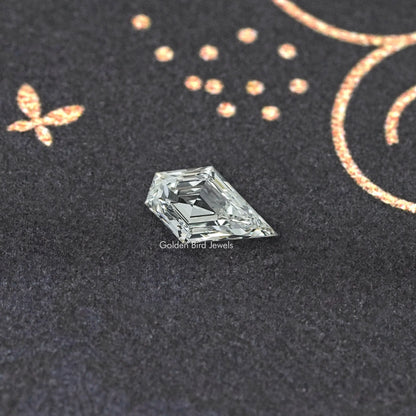 Clear arrow-shaped lab-grown diamond, faceted with sharp prismatic reflections