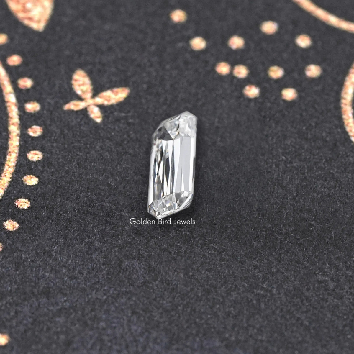 Vertical rectangular lab-grown diamond with crisp facets on dark jewelry backing