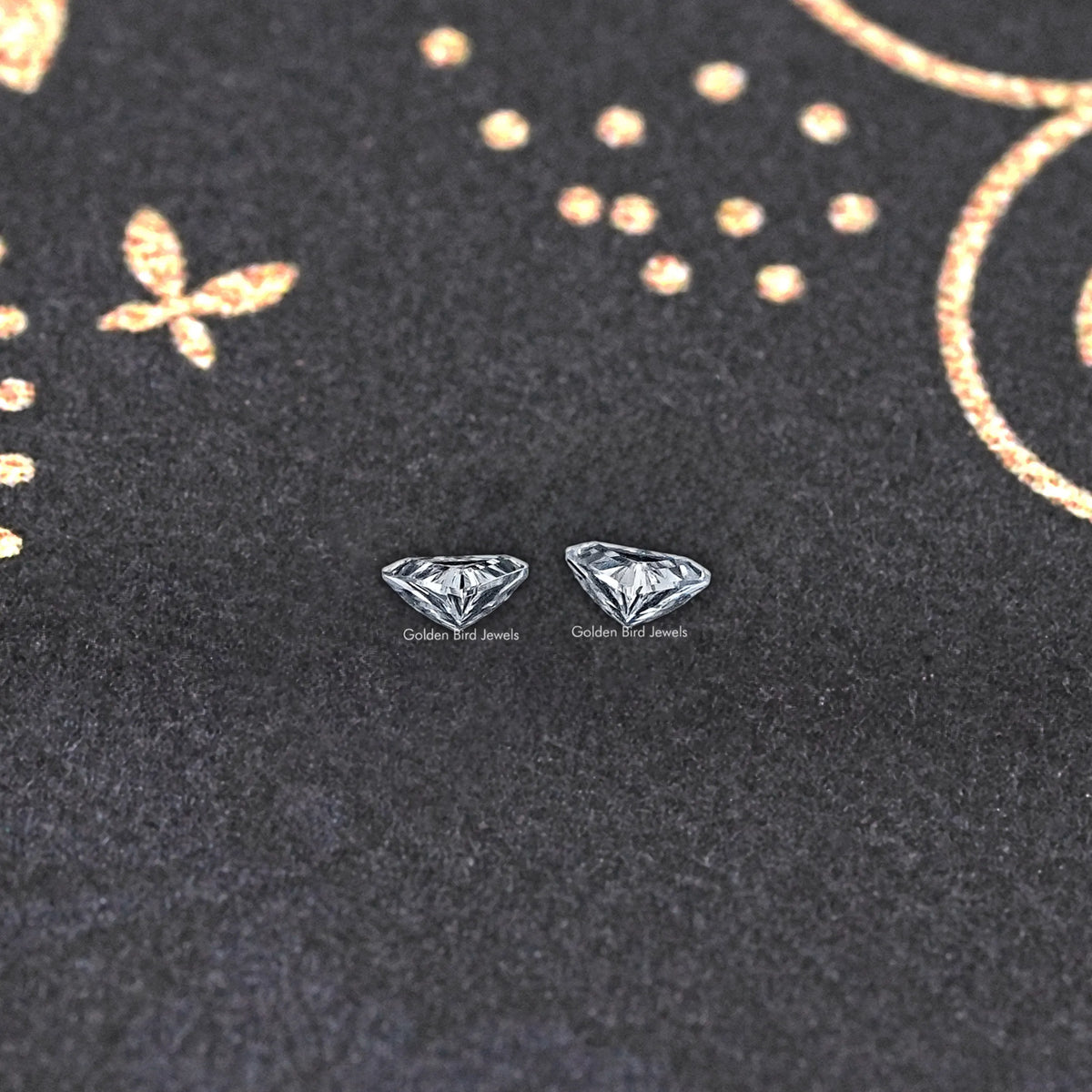 Triangle lab-grown diamond studs with step-cut facets on dark display