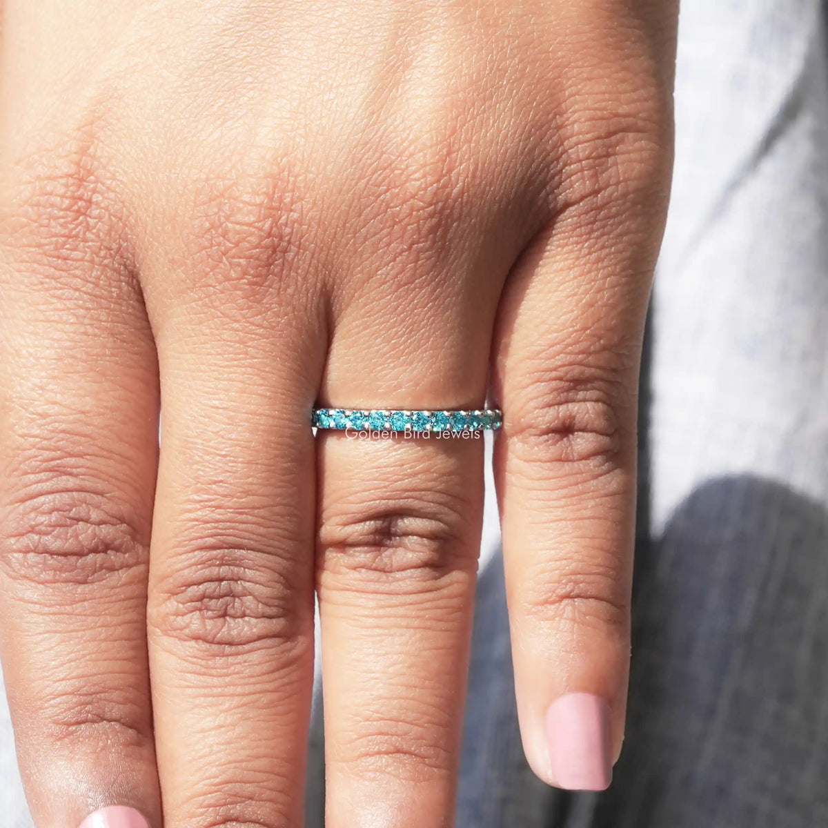View of Blue Round Cut Moissanite Solitaire Ring in prongs setting 