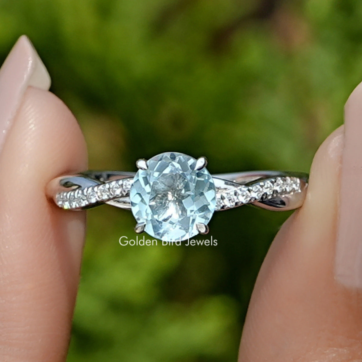 Front view of  Round Cut Gemstone Ring in two fingers 