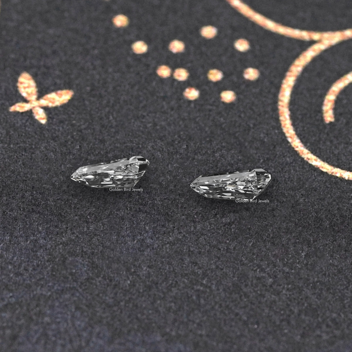 Arrow-cut lab-grown diamond pair, side view highlighting reflective facets