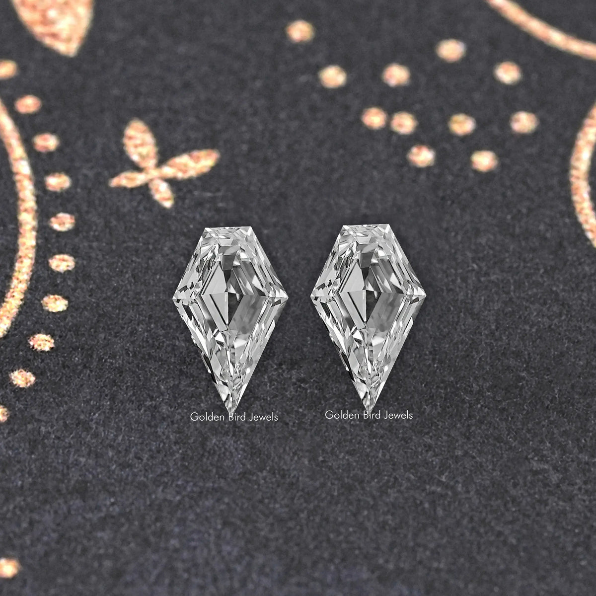 Two clear arrow-shaped lab-grown diamonds with defined points and facet lines