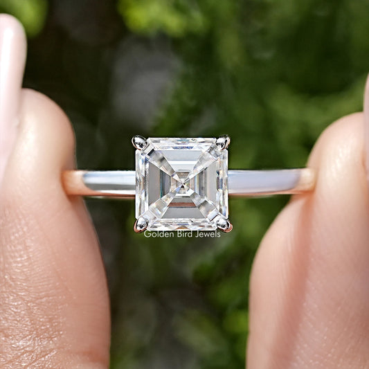 Close-up of asscher-cut moissanite solitaire ring with square crystal and prong setting