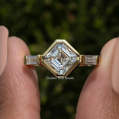 Three-stone asscher-cut lab diamond ring with baguette side stones, yellow gold tone