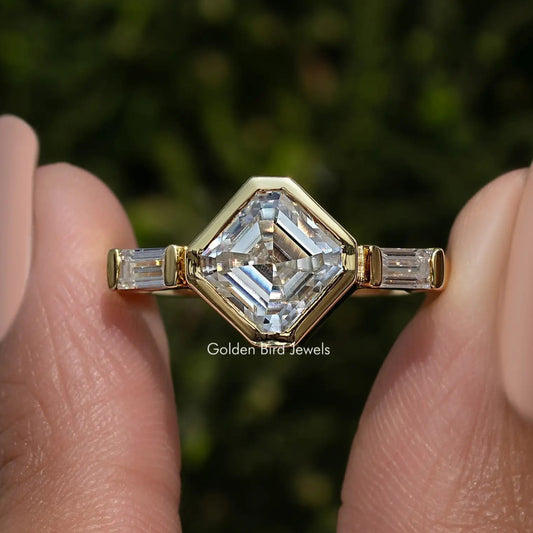 Three-stone asscher-cut lab diamond ring with baguette side stones, yellow gold tone