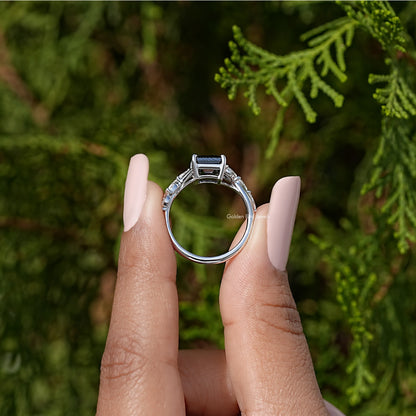 Sterling silver ring top view with black asscher-cut center and baguette halo stones