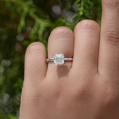 Asscher-cut moissanite solitaire ring on hand, square center stone and thin metal band