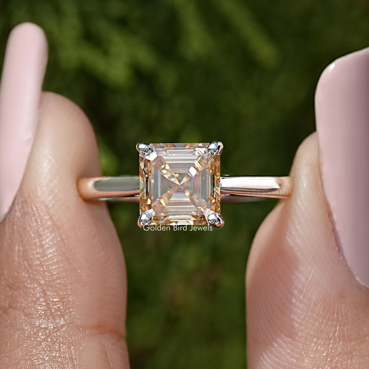Asscher-cut moissanite solitaire ring in sterling silver, close-up of square stone and prongs.