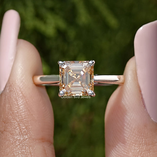 Asscher-cut moissanite solitaire ring in sterling silver, close-up of square stone and prongs.