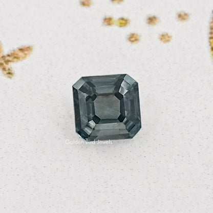 Gray asscher-cut moissanite gemstone, square step facets