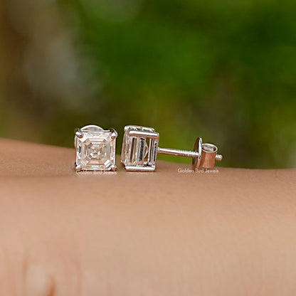 Pair of Asscher-cut moissanite stud earrings, square stones on white gold posts.