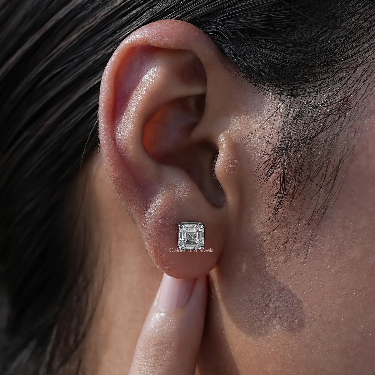 Close view of diamond stud earrings in prongs setting 