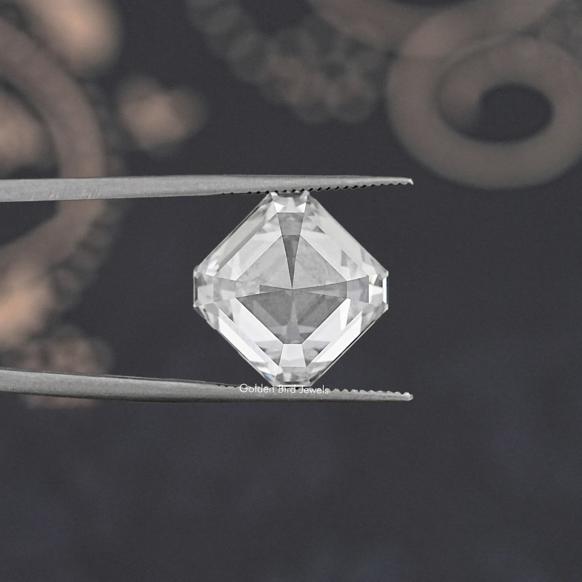 Asscher-cut lab-grown diamond viewed from above in tweezers, clear facets
